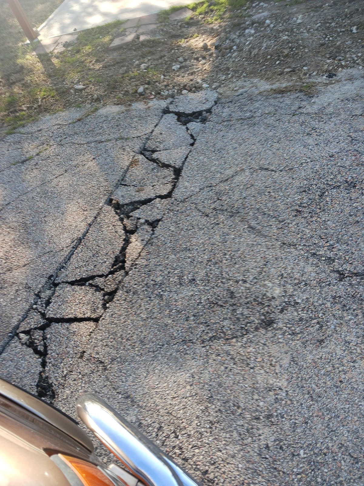A driveway repaired and patched after water line work